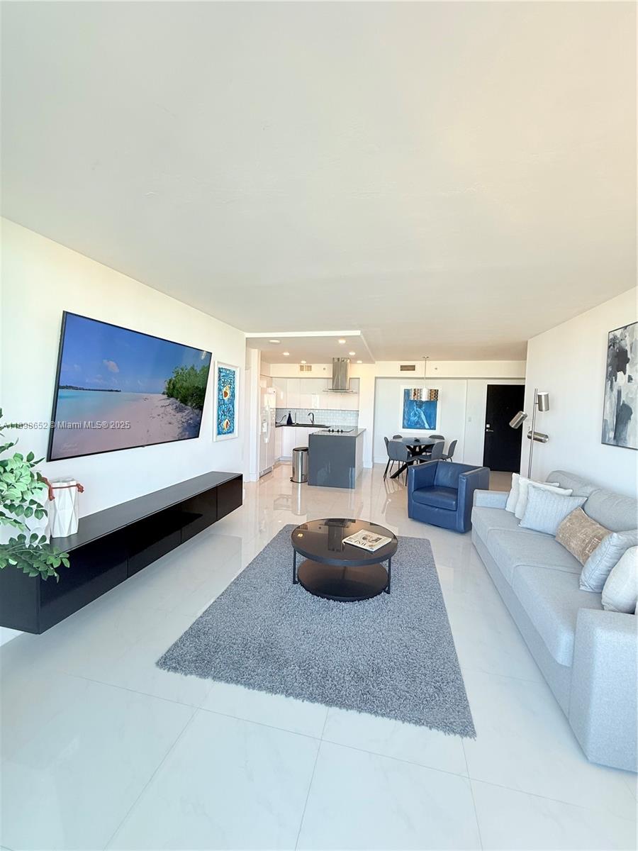 90 Alton Road, Unit 909 Miami Beach, FL 33139 - Photo 20 of 37 a living room with furniture and a potted plant