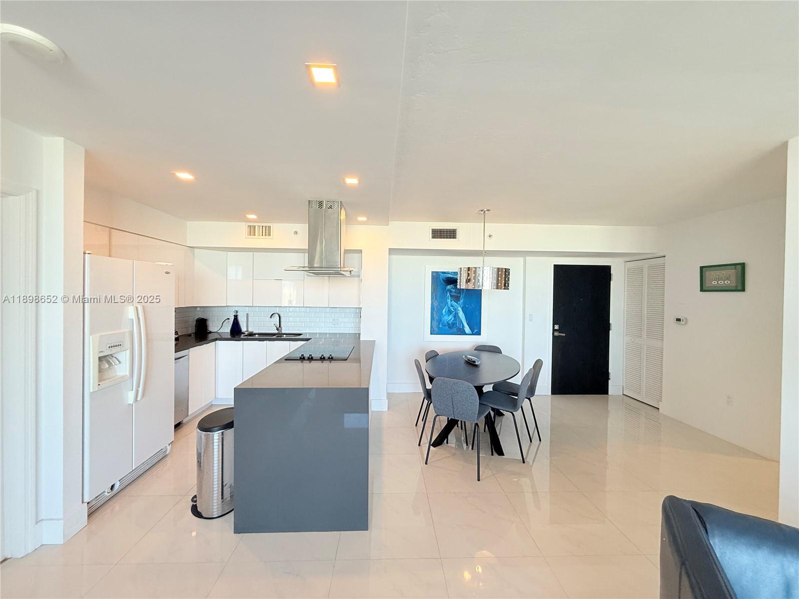 90 Alton Road, Unit 909 Miami Beach, FL 33139 - Photo 22 of 37 a view of kitchen with dining area refrigerator and window