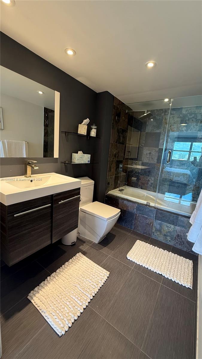 90 Alton Road, Unit 909 Miami Beach, FL 33139 - Photo 3 of 37 a bathroom with a double vanity sink and a mirror