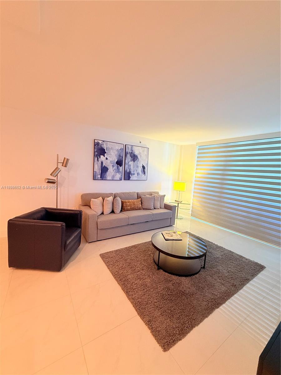90 Alton Road, Unit 909 Miami Beach, FL 33139 - Photo 37 of 37 a living room with furniture and a wooden floor