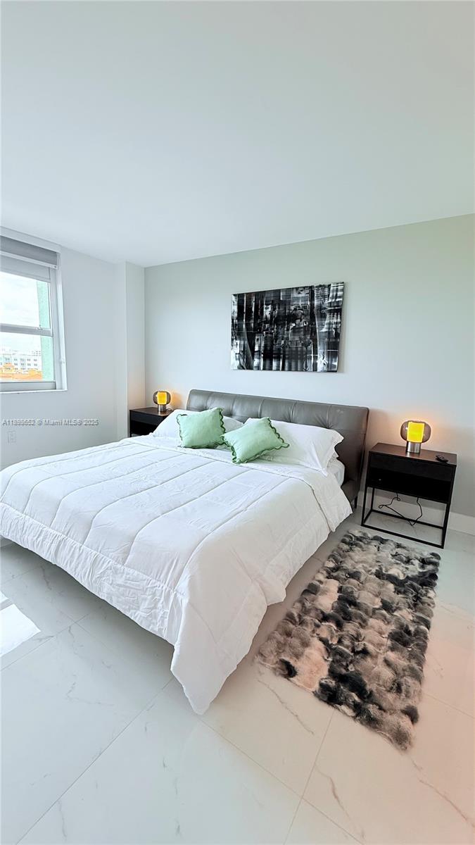 90 Alton Road, Unit 909 Miami Beach, FL 33139 - Photo 6 of 37 a bedroom with a bed and a couch