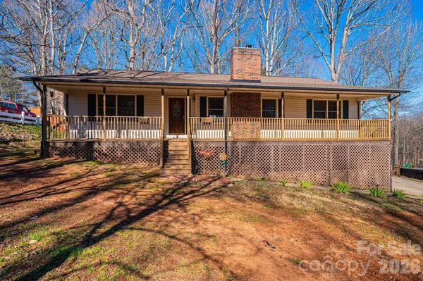 a view of a house with a small yard and wooden fence