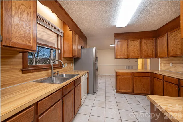 a kitchen with stainless steel appliances granite countertop a sink and cabinets