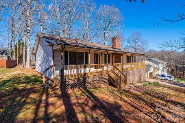 a view of a house with a wooden deck