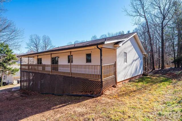 a view of a house with a wooden fence