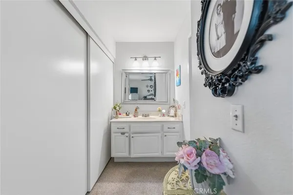 a bathroom with a sink mirror and vanity