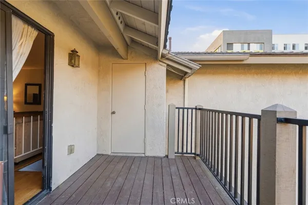 a view of a balcony with wooden floor