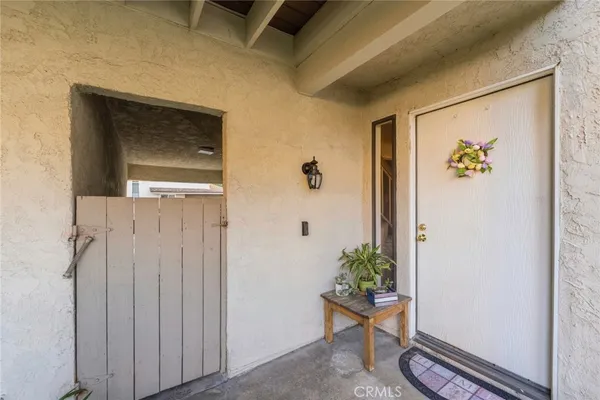 a view of a hallway with wooden floor and a potted plant