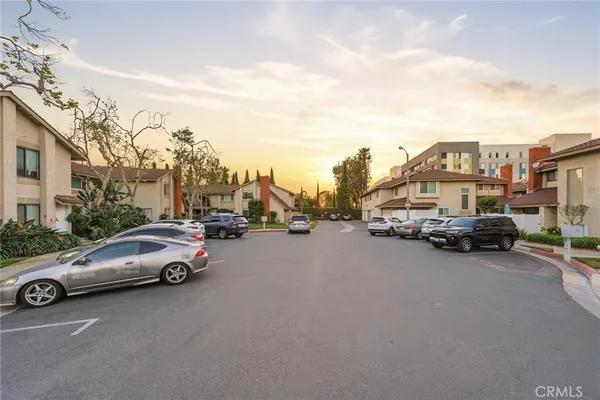 a view of cars parked in front of a house