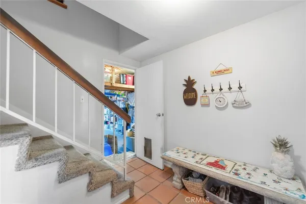 a view of entryway with furniture and stairs