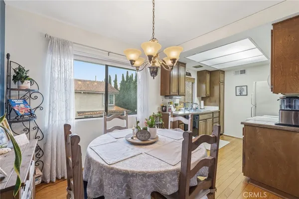 a view of a dining room with furniture and a chandelier