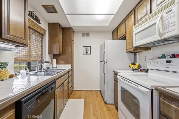 a kitchen with a sink a refrigerator and a stove