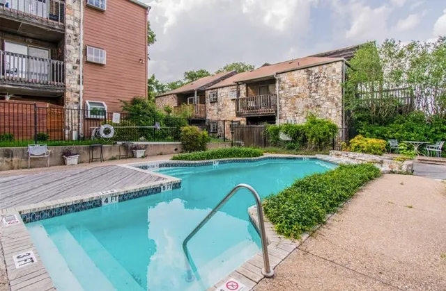 a aerial view of a house with swimming pool and green space
