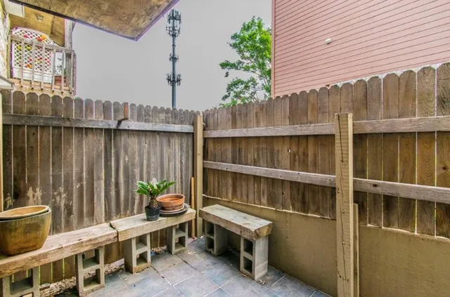 a backyard of a house with table and chairs