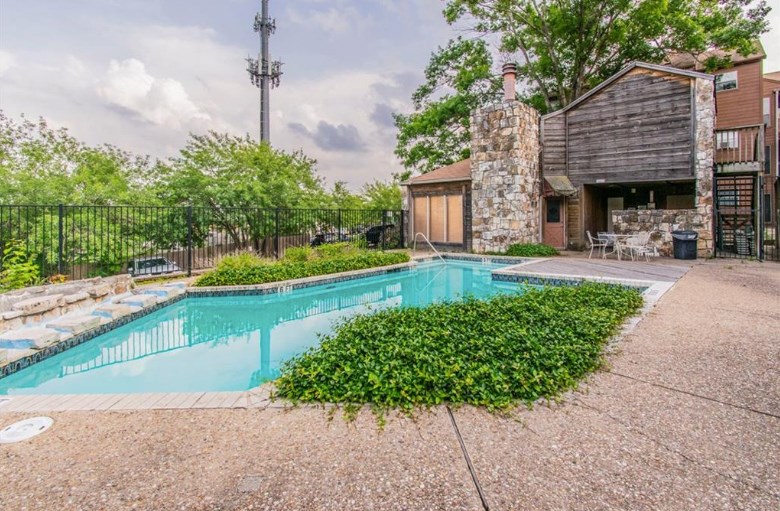 6903 Deatonhill Drive, Unit 22 Austin, TX 78745 - Photo 10 of 12 a front view of a house with a yard table and chairs