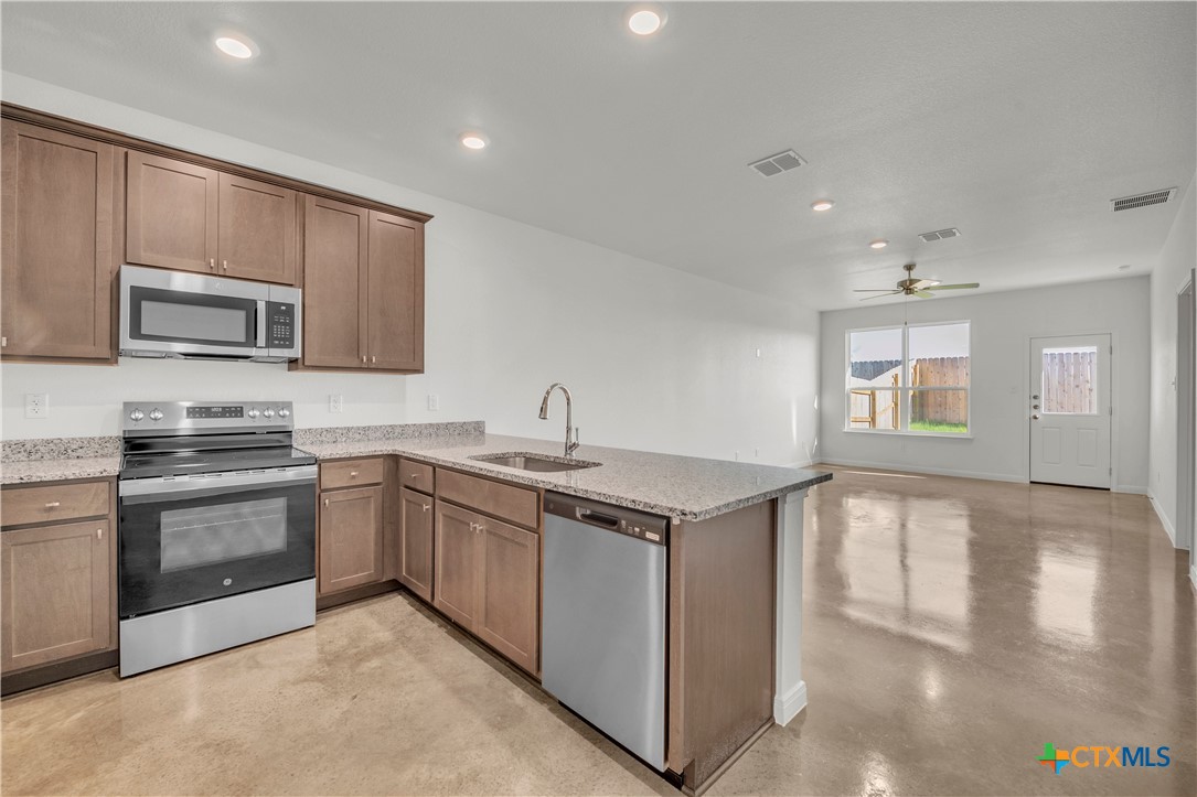2906 Quail Rdg Lane Temple, TX 76501 - Photo 5 of 17 a kitchen with sink a microwave and stove
