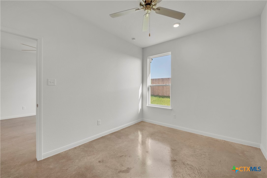 2906 Quail Rdg Lane Temple, TX 76501 - Photo 10 of 17 an empty room with a window and a ceiling fan