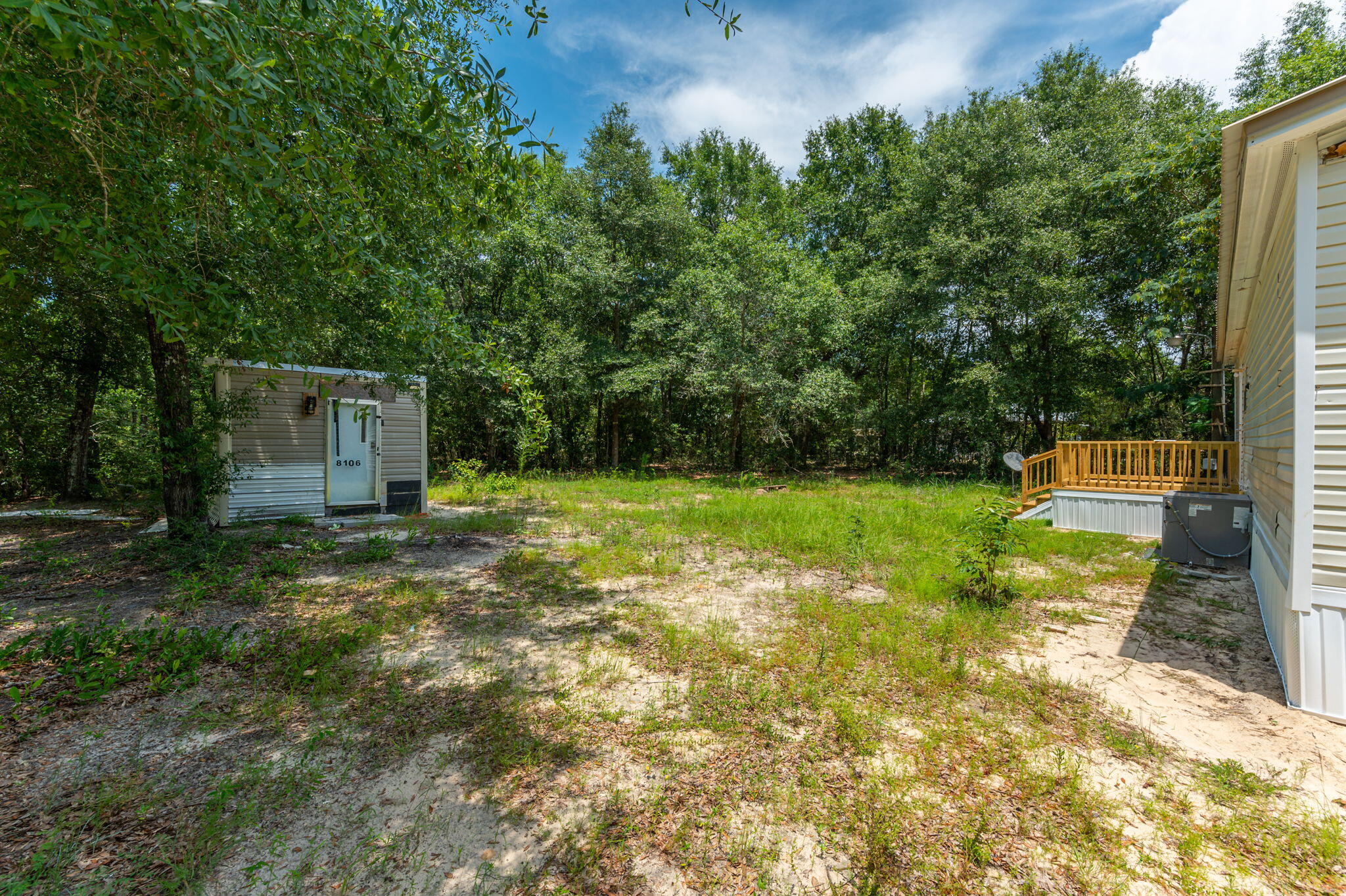 4231 Painter Branch Road Crestview, FL 32539 - Photo 14 of 39 a backyard of a house with table and chairs