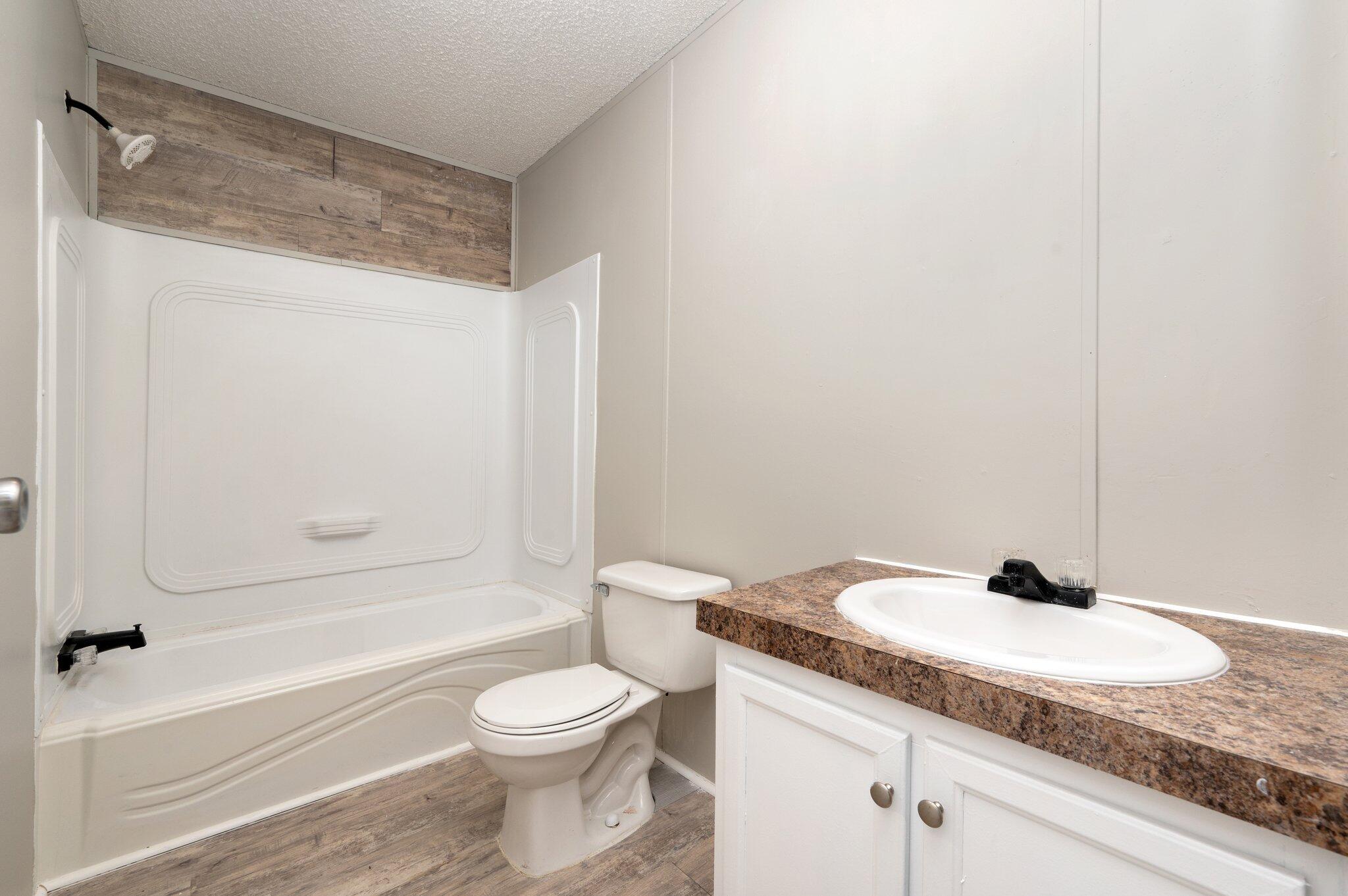 4231 Painter Branch Road Crestview, FL 32539 - Photo 10 of 39 a bathroom with a granite countertop sink toilet and shower