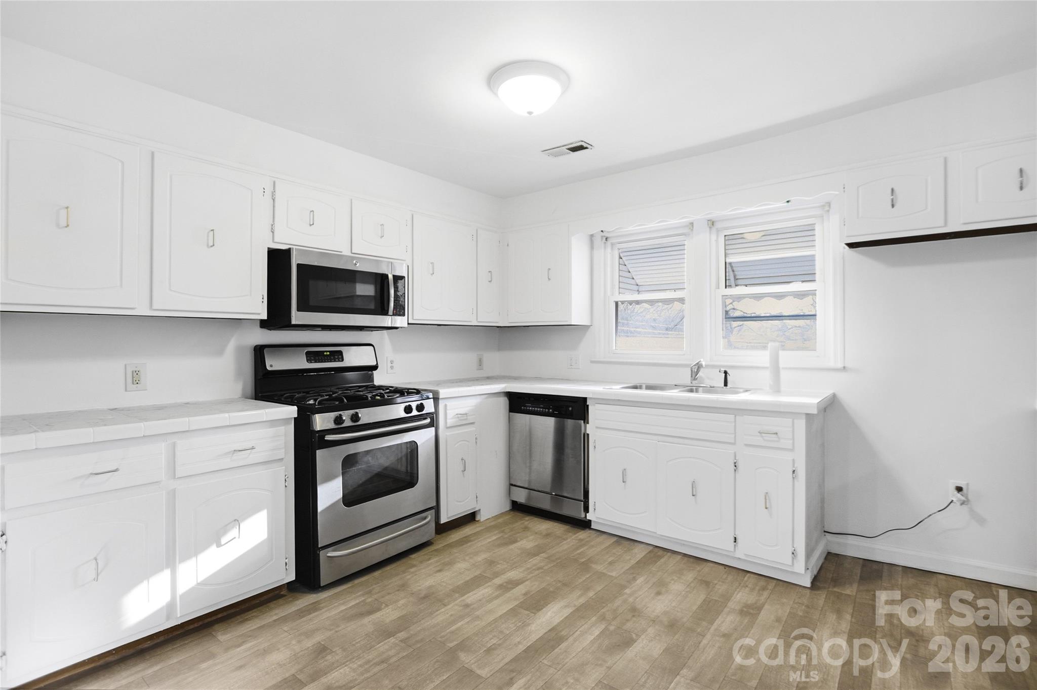 213 Jewel Street Chester, SC 29706 - Photo 3 of 21 a kitchen with granite countertop white cabinets and appliances