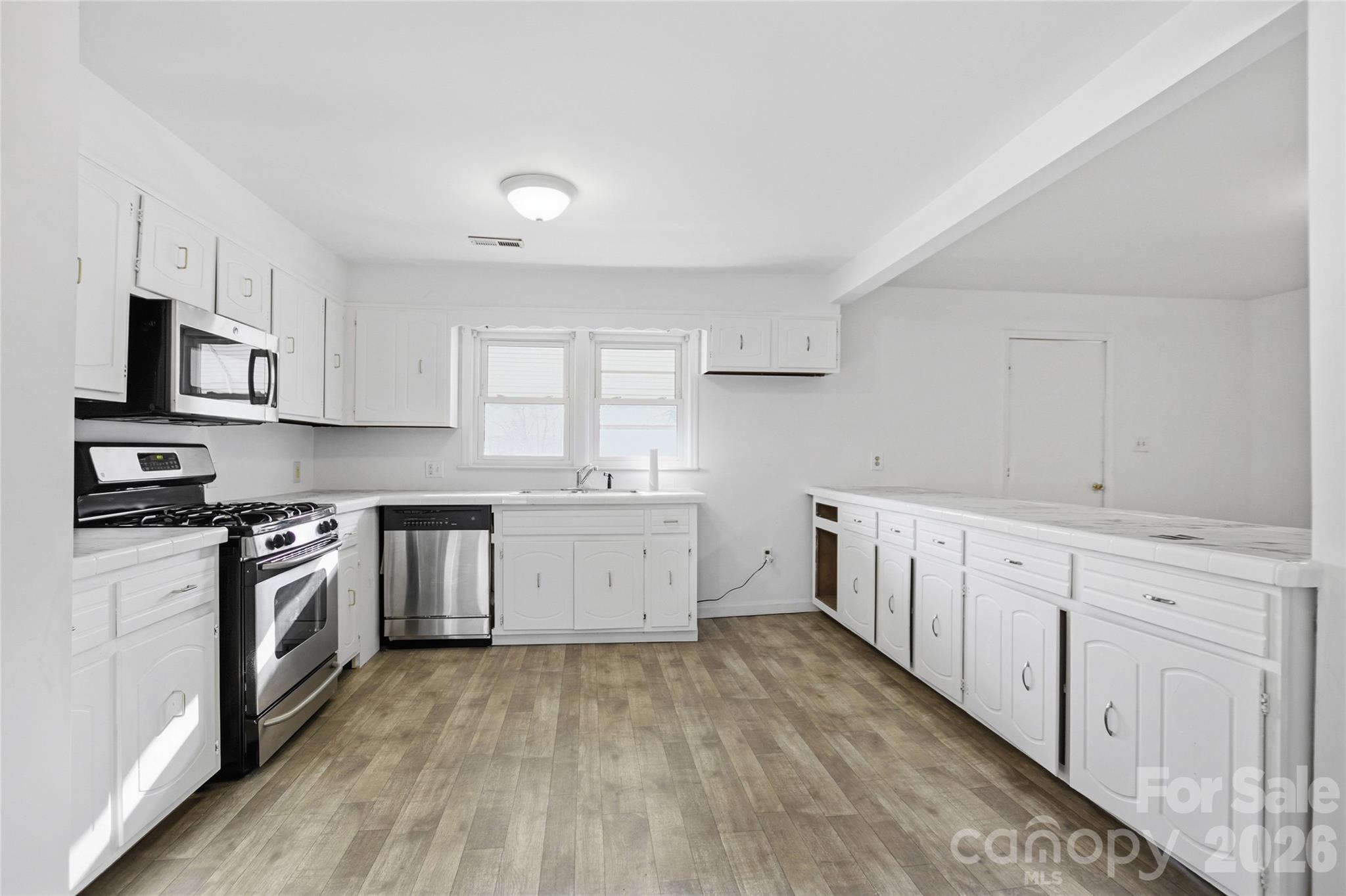 213 Jewel Street Chester, SC 29706 - Photo 4 of 21 a kitchen with granite countertop a stove top oven sink and cabinets