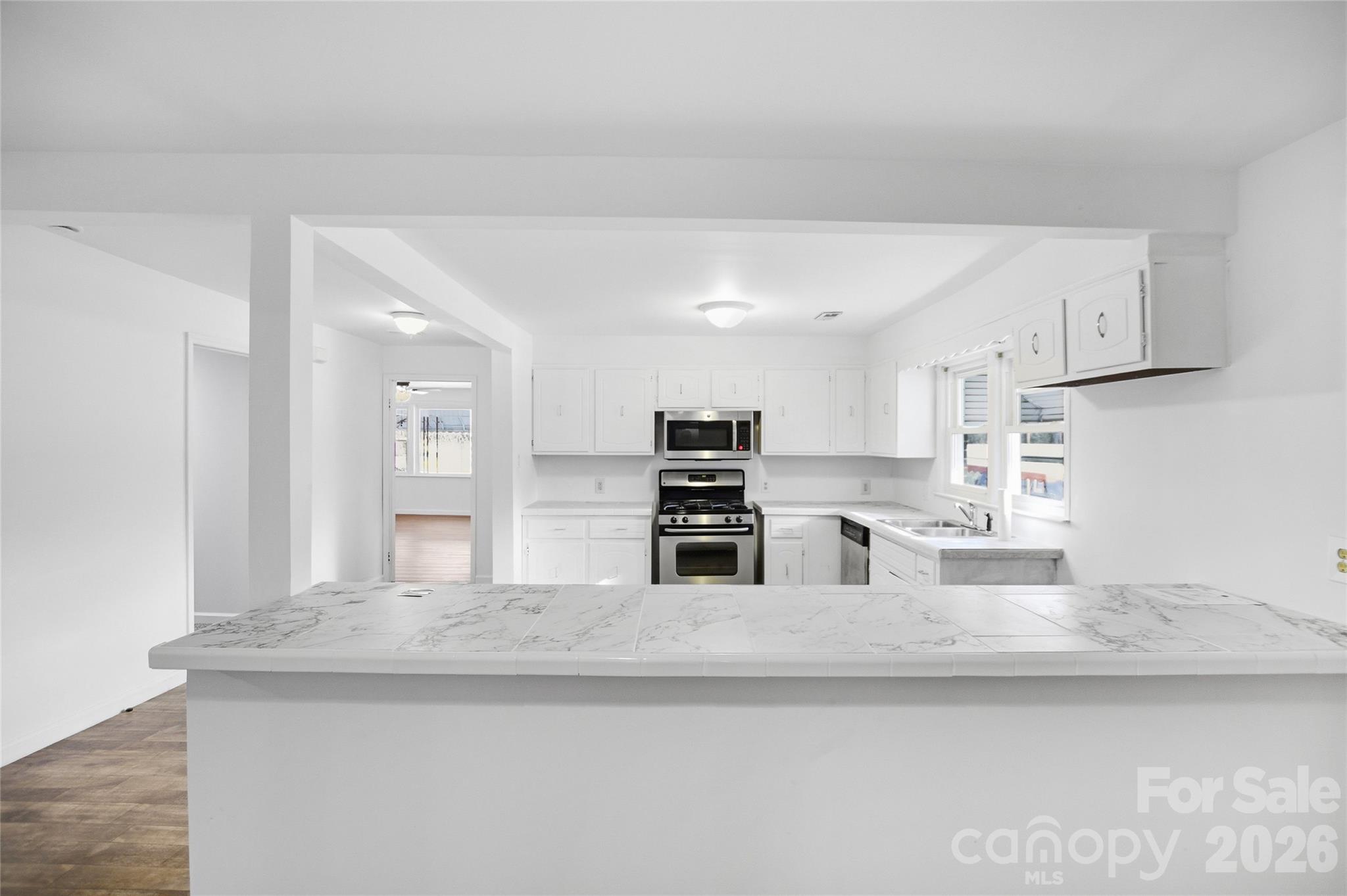 213 Jewel Street Chester, SC 29706 - Photo 9 of 21 a large kitchen with kitchen island a sink stainless steel appliances and cabinets