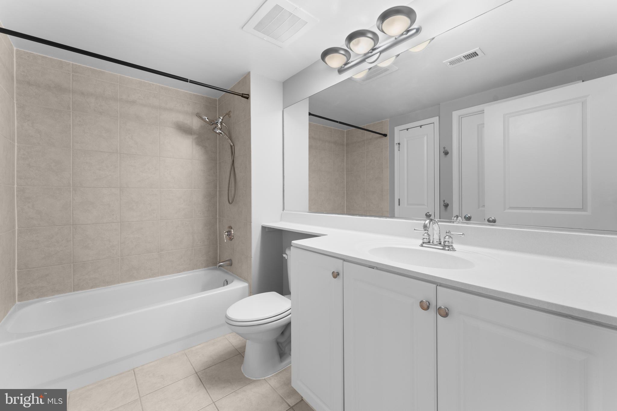 851 North Glebe Road, Unit 1514 Arlington, VA 22203 - Photo 21 of 47 a bathroom with a granite countertop sink a toilet and shower