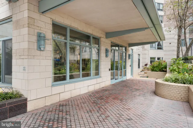 a living room with furniture a chandelier and a large window