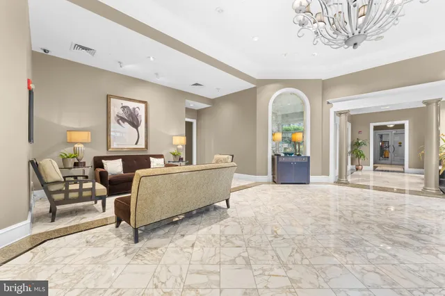 a view of a workspace with furniture and a bookshelf