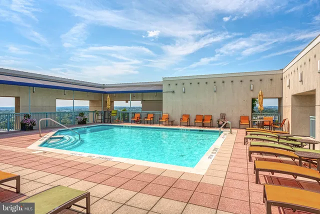 a roof deck with a table and chairs