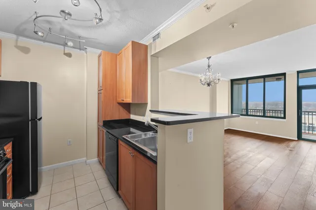 a kitchen with granite countertop a refrigerator and a sink