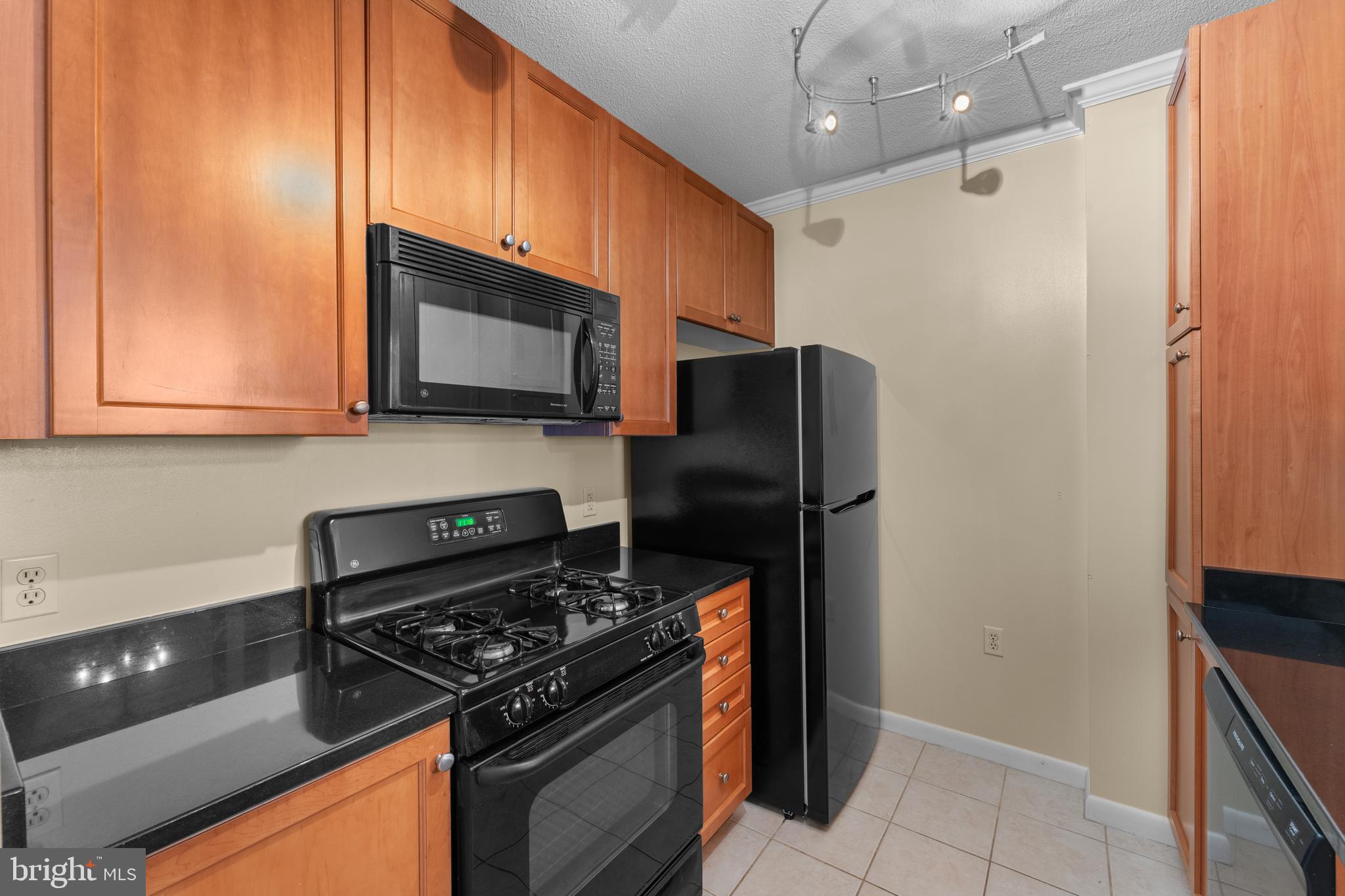 851 North Glebe Road, Unit 1514 Arlington, VA 22203 - Photo 7 of 47 a kitchen with stainless steel appliances granite countertop a refrigerator and a stove top oven