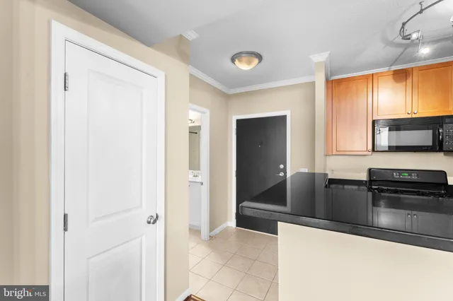 a kitchen with granite countertop a refrigerator and a sink