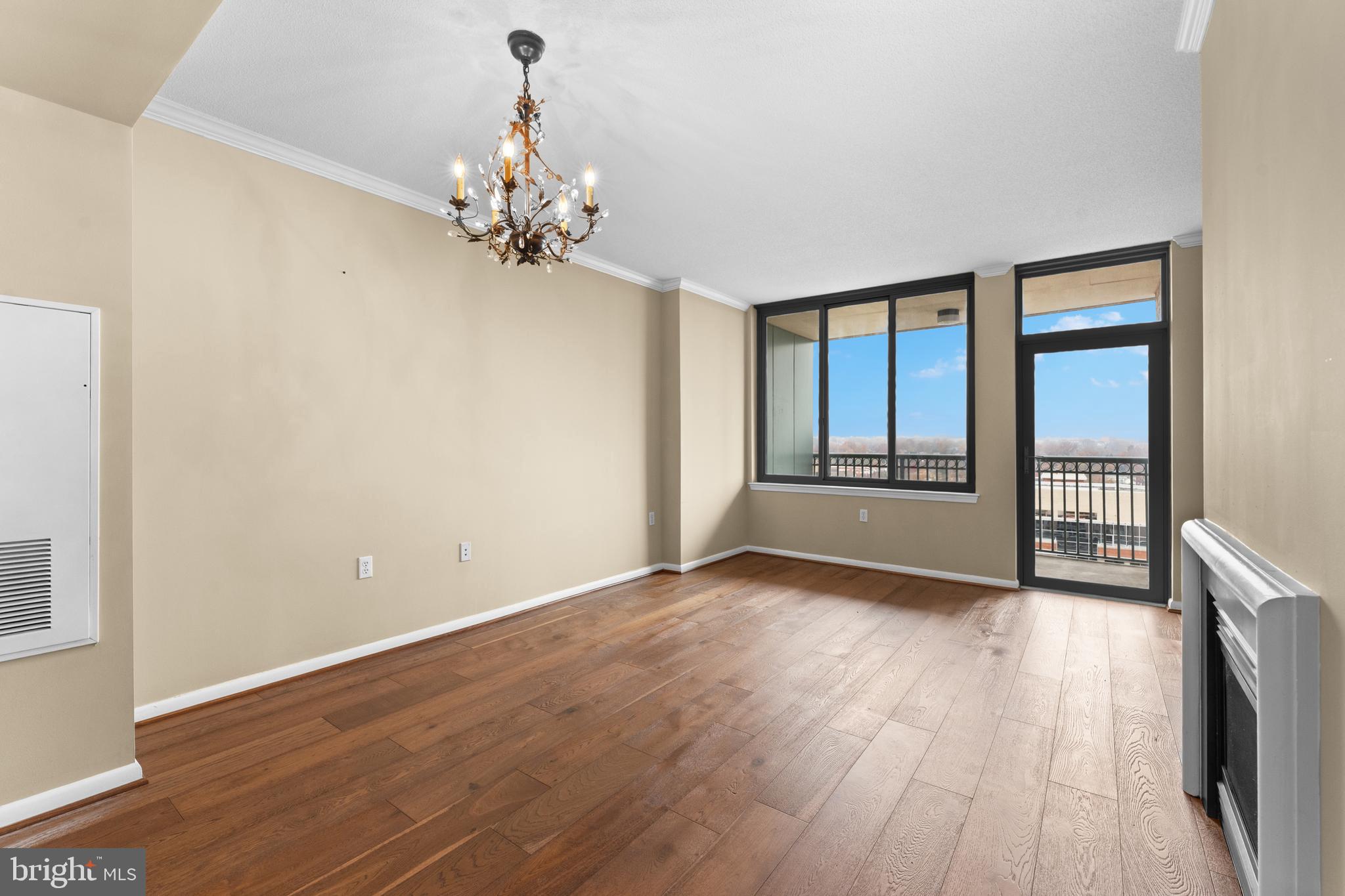 851 North Glebe Road, Unit 1514 Arlington, VA 22203 - Photo 10 of 47 a view of an empty room with window and wooden floor