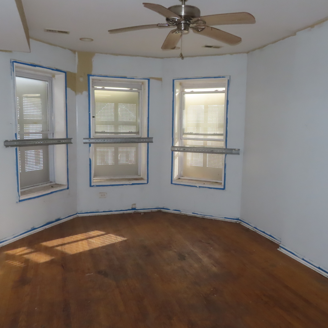 7046 South Normal Boulevard Chicago, IL 60621 - Photo 13 of 41 an empty room with windows and fan