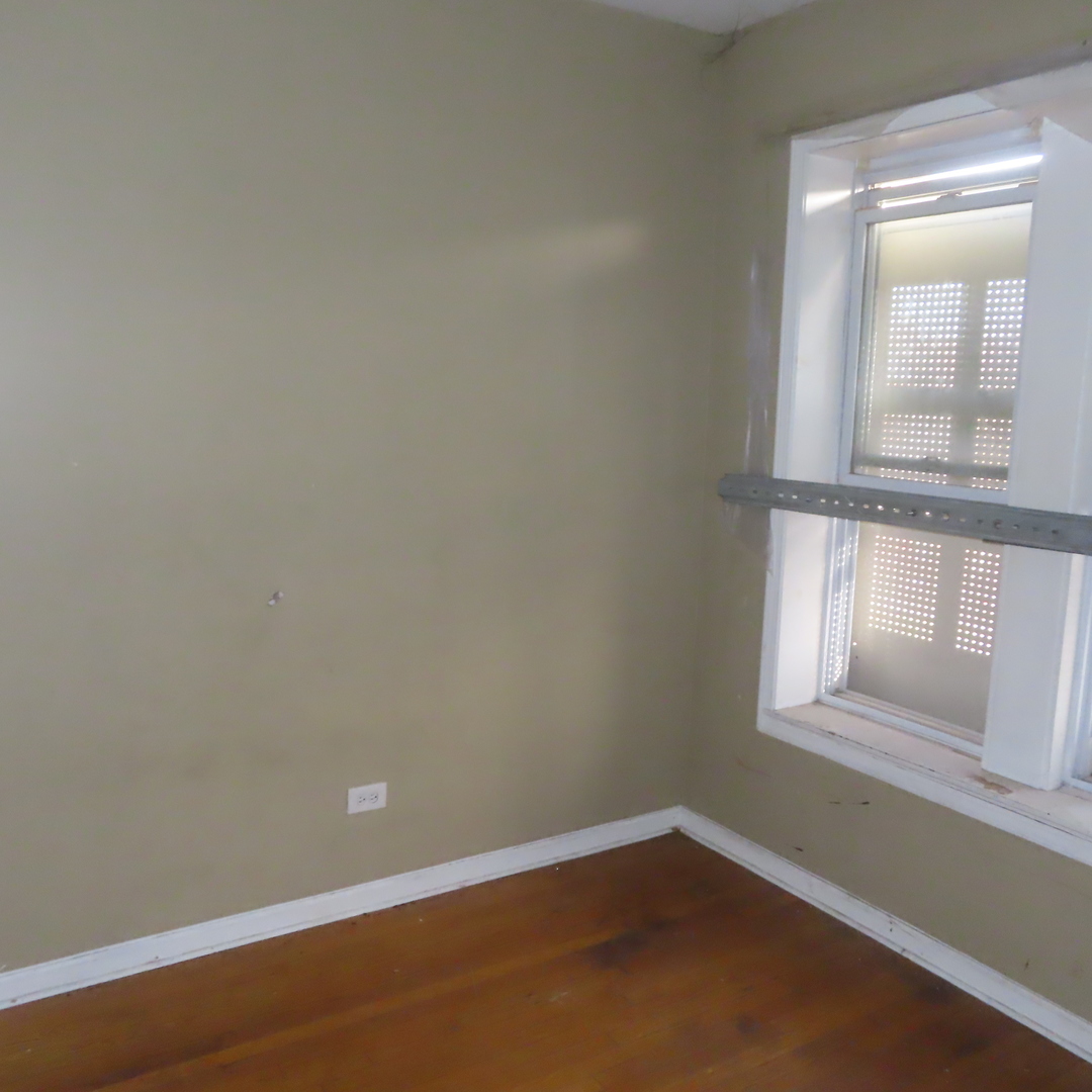 7046 South Normal Boulevard Chicago, IL 60621 - Photo 14 of 41 an empty room with a window