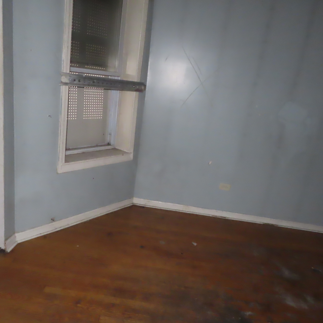 7046 South Normal Boulevard Chicago, IL 60621 - Photo 16 of 41 an empty room with a window