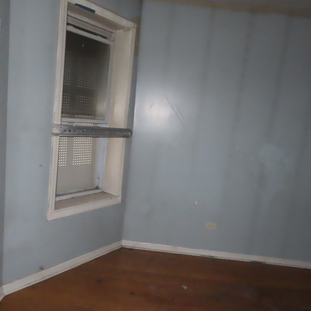 7046 South Normal Boulevard Chicago, IL 60621 - Photo 21 of 41 an empty room with a window