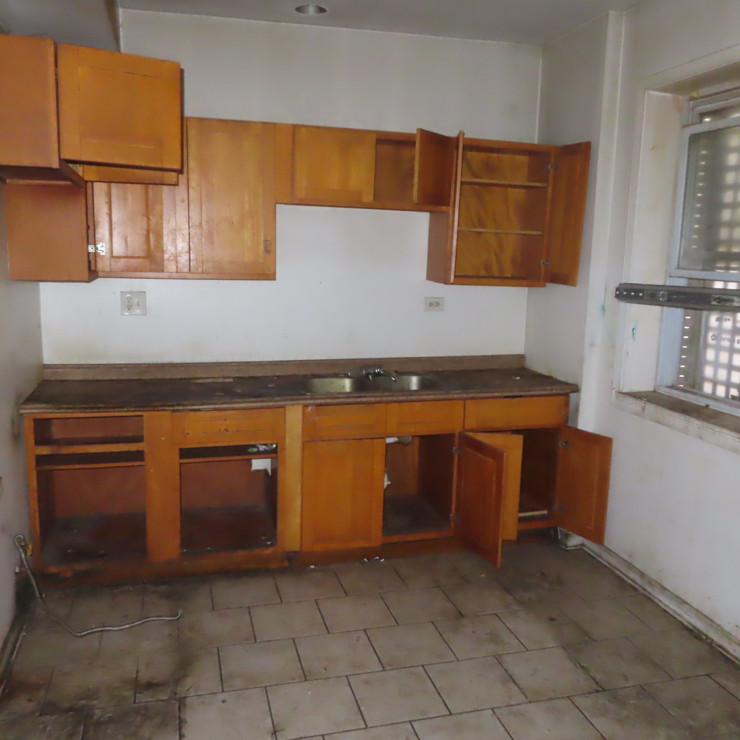 7046 South Normal Boulevard Chicago, IL 60621 - Photo 3 of 41 a stove top oven sitting inside of a kitchen