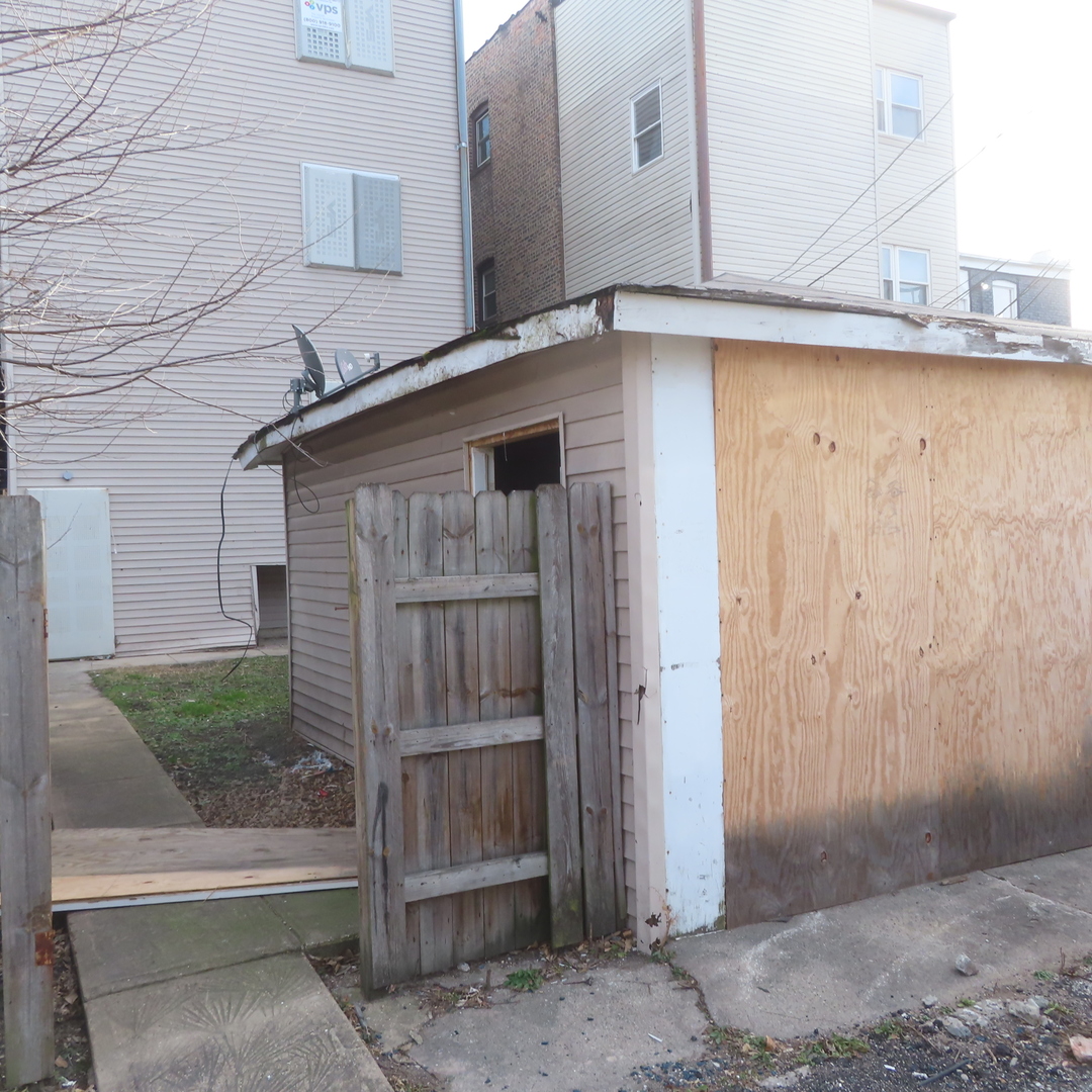 7046 South Normal Boulevard Chicago, IL 60621 - Photo 37 of 41 a front view of a house with a garage