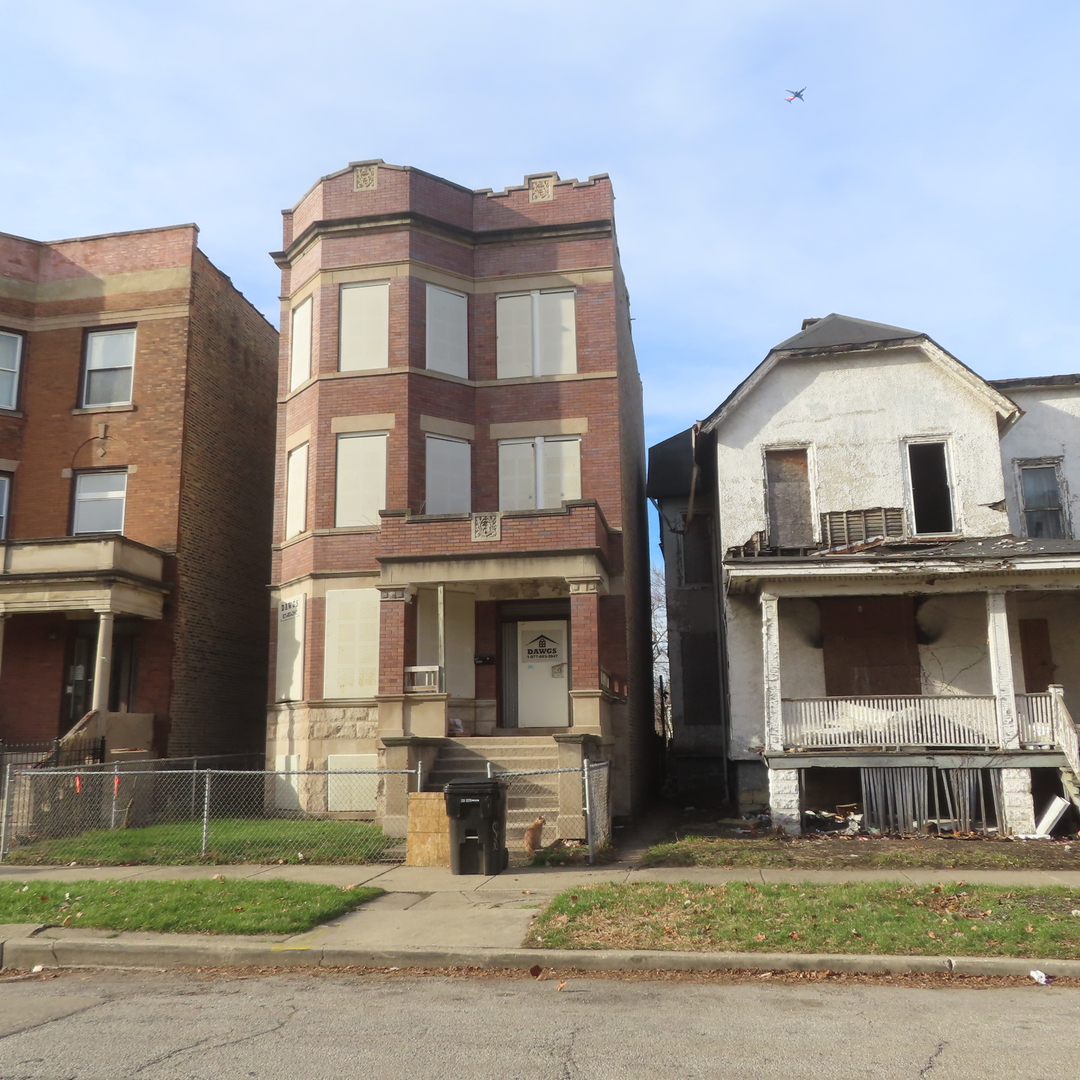7046 South Normal Boulevard Chicago, IL 60621 - Photo 41 of 41 a front view of a residential apartment building with a yard