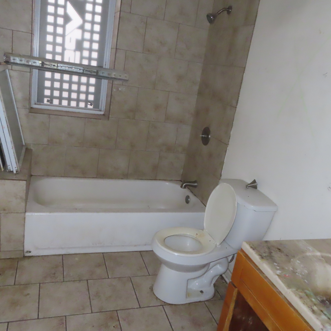 7046 South Normal Boulevard Chicago, IL 60621 - Photo 7 of 41 a bathroom with a toilet and a bathtub