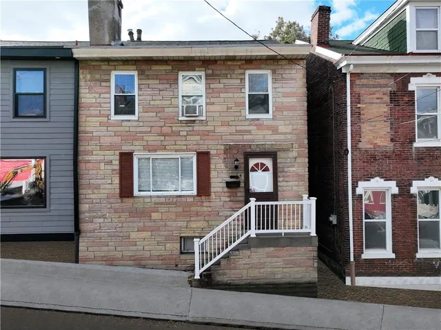 a front view of a house with stairs