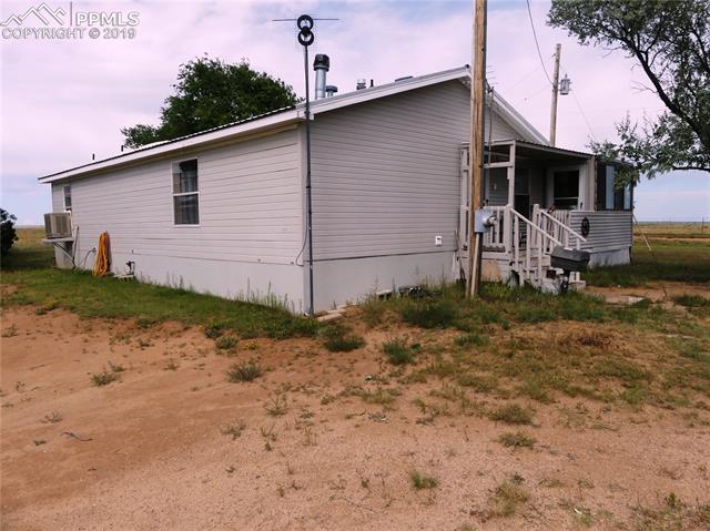 30150 Antioch Road Yoder, CO 80864 - Photo 6 of 36 Rear (west) and south end. Covered porch