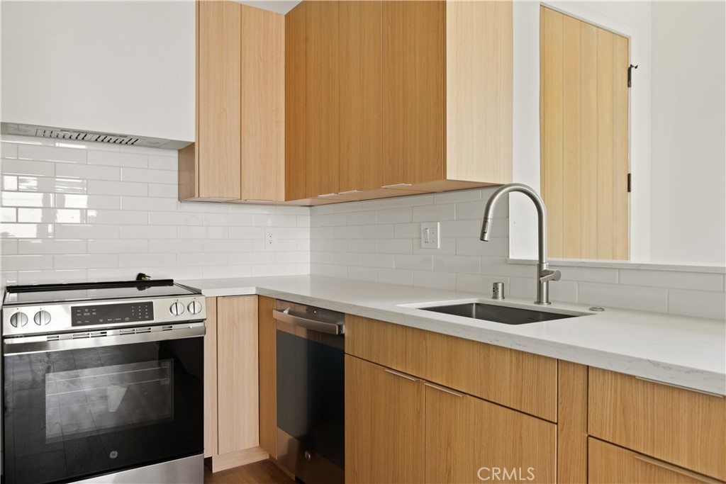 2671 1/2 Benedict Street Los Angeles, CA 90039 - Photo 13 of 39 a kitchen with stainless steel appliances granite countertop a sink a stove and oven
