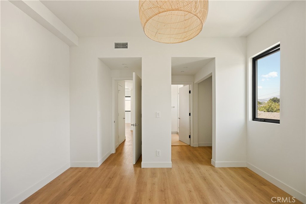 2671 1/2 Benedict Street Los Angeles, CA 90039 - Photo 23 of 39 a view of a room with wooden floor and mirror