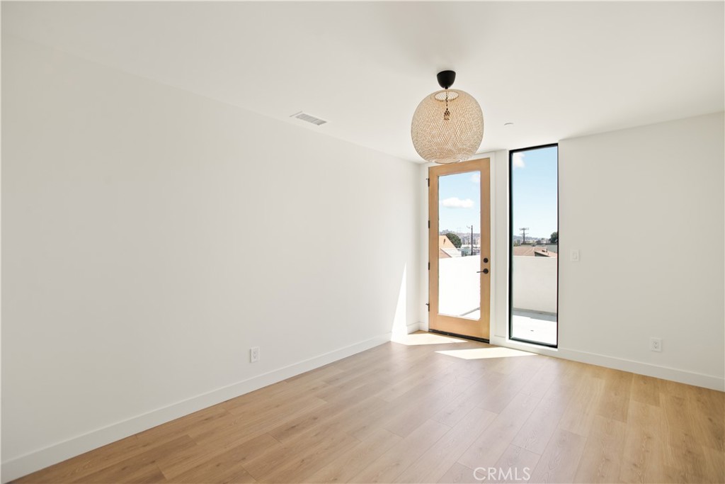 2671 1/2 Benedict Street Los Angeles, CA 90039 - Photo 28 of 39 a view of an empty room with wooden floor and a window