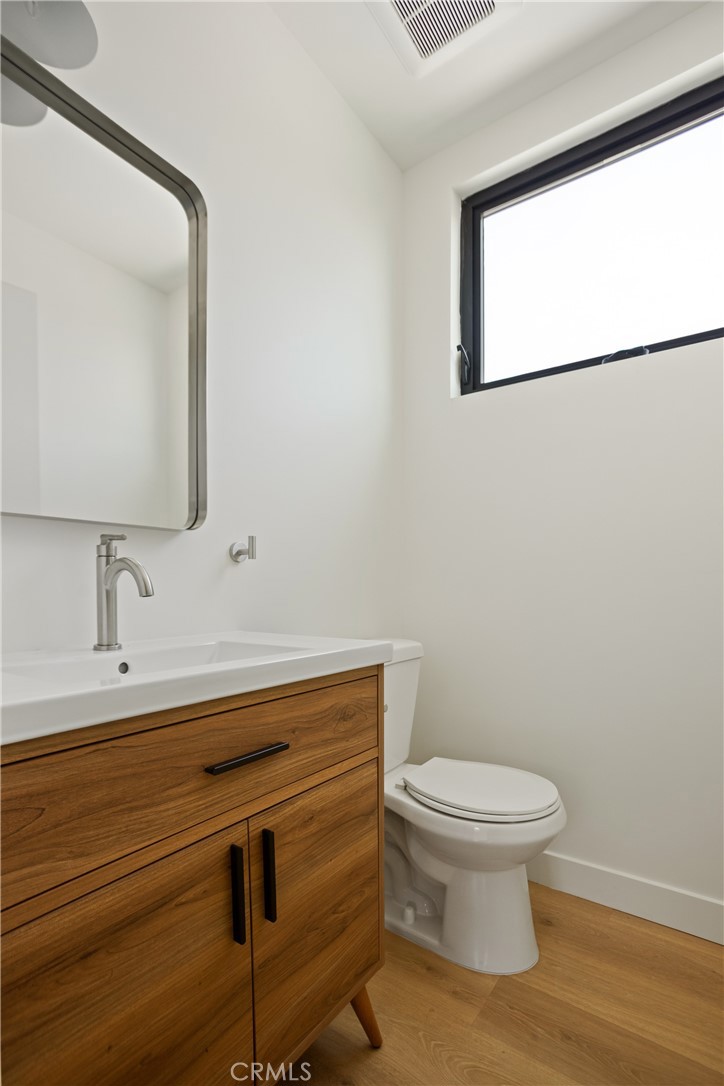 2671 1/2 Benedict Street Los Angeles, CA 90039 - Photo 29 of 39 a bathroom with a toilet a sink and mirror