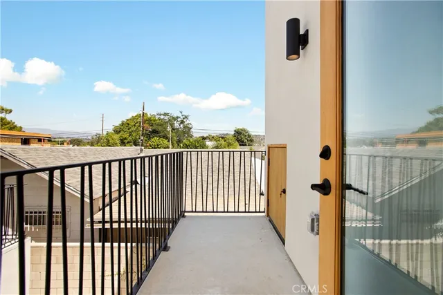 a view of a balcony with wooden fence