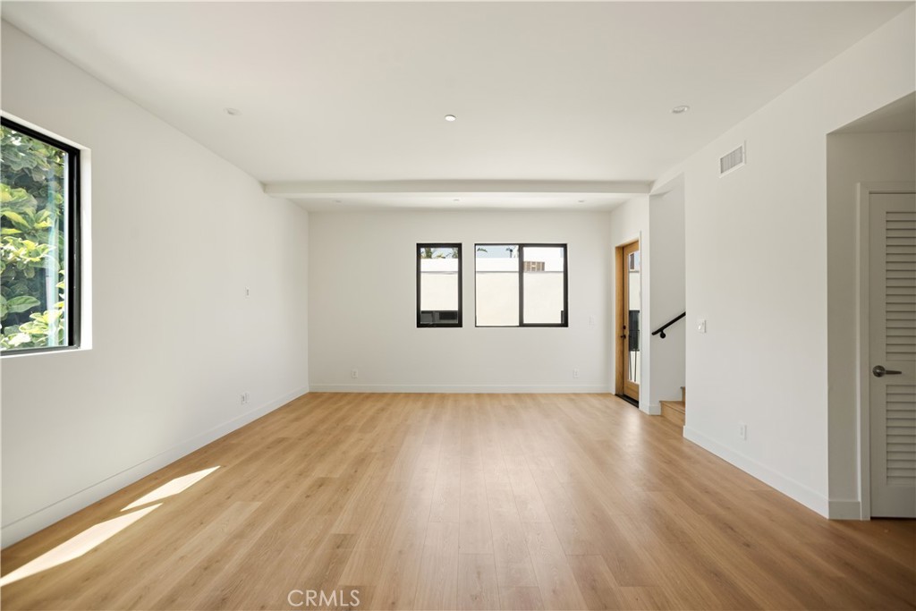 2671 1/2 Benedict Street Los Angeles, CA 90039 - Photo 32 of 39 an empty room with wooden floor and windows